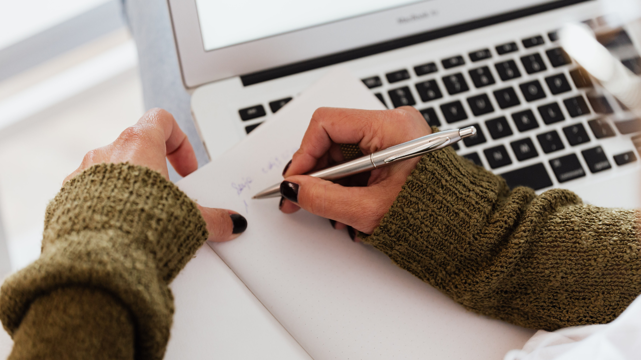 Woman writting at desk