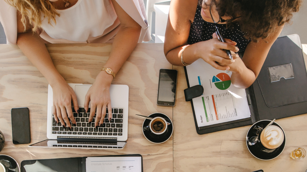 Two women working on business ecosystem in a cafe Two women working on business ecosystem in a cafe