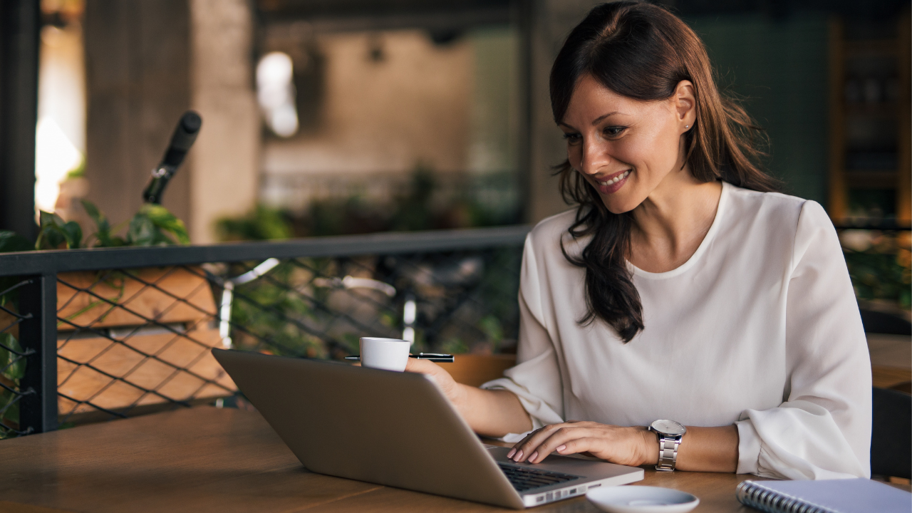 Woman business woner sitting at computer smiling Woman business woner sitting at computer smiling